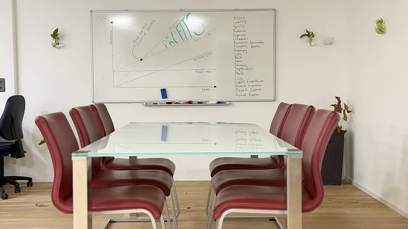 Meeting table with red chairs and whiteboard at Webzenz Switzerland